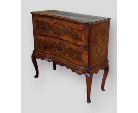 A late 18th or early 19th Century Italian walnut commode, with two drawers with brass handles raised upon cabriole legs with 