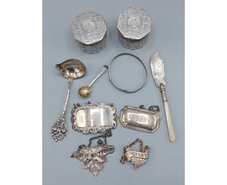 A pair of Victorian London silver topped glass dressing table bottles, together with four silver decanter labels, a silver bu