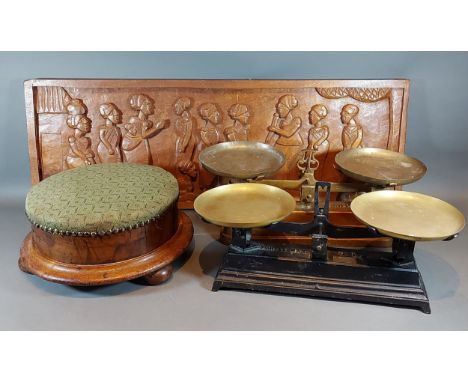 A Victorian walnut and upholstered circular footstool, together with a carved wooden wall plaque and two 5kg balance scales 