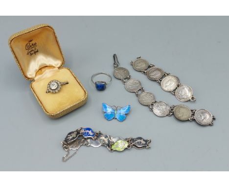 A silver and enamel set brooch in the form of a butterfly together with two coin bracelets, an enamel set bracelet, two silve