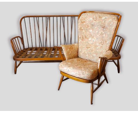 An Ercol stick back sofa together with a matching armchair 