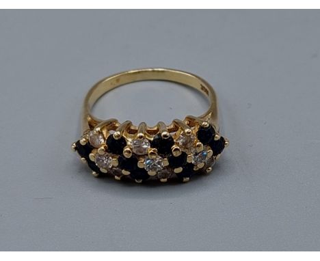 An 18ct gold Sapphire and diamond cluster ring, ring size P, 5.2gms 