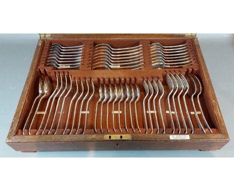 An oak cased silver plated canteen of cutlery by Harrods 