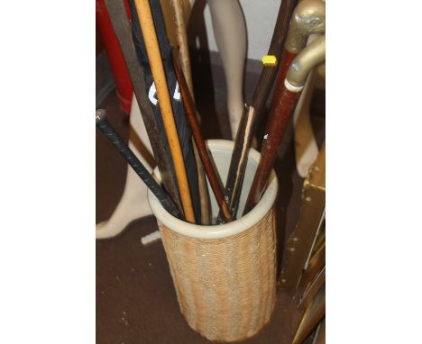 A CERAMIC STICK STAND AND A QUANTITY OF WALKING STICKS