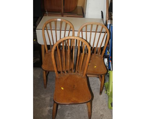 A FORMICA TABLE AND THREE STICK CHAIRS