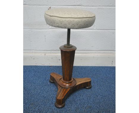 A REGENCY ROSEWOOD SWIVEL PIANO STOOL, with beige upholstered circular seat, on an octagonal support, raised on a shaped base