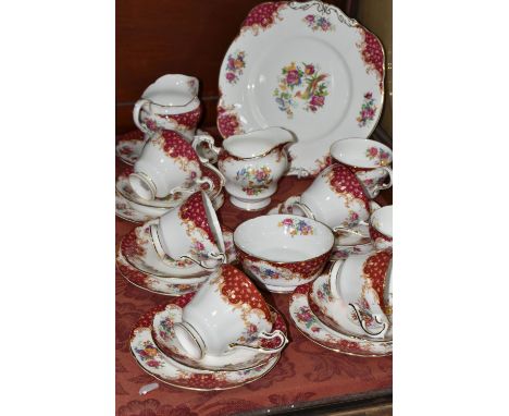 A TWENTY TWO PIECE PARAGON 'ROCKINGHAM' PATTERN PART TEA SET, comprising a cake plate, two cream jugs (one chipped and cracke
