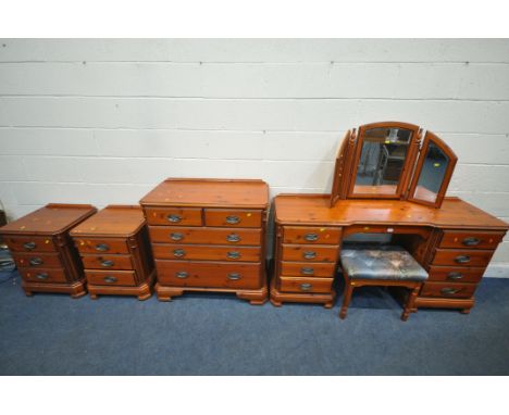 A DUCAL PINE SIX PIECE BEDROOM SUITE, comprising a dressing table, fitted with nine drawers, width 156cm x depth 46cm x heigh