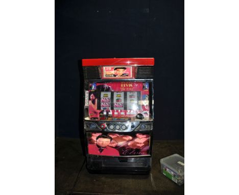 A MODERN JULIAN FRUIT MACHINE with Elvis 'The King' graphics (powers up but doesn't appear to function, no key) with a box of