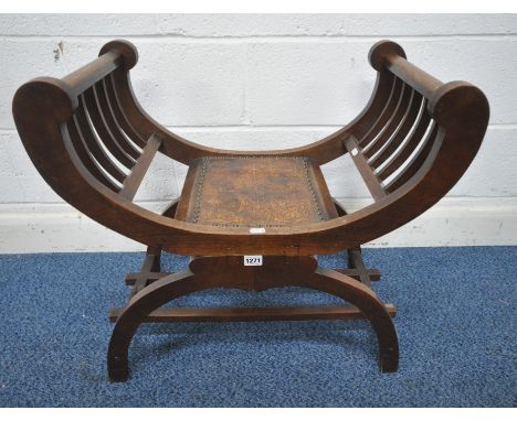 AN EARLY 20TH CENTURY OAK SAVONAROLA STOOL, with slatted armrests, leather seat, raised on an X frame, united by stretchers, 