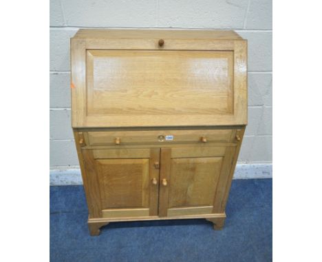 POSSIBLY TERRY 'RAM MAN' HARRINGTON, A GOOD QUALITY OAK BUREAU, the fall front door enclosing a fitted interior, above a sing