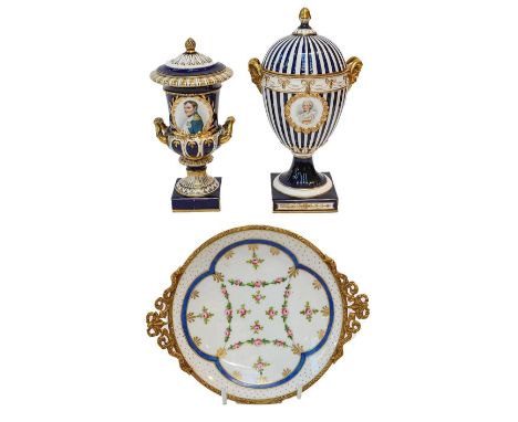 A late 19th century Continental blue ground and gilt decorated pedestal vase and cover, the striped body with ribbon tied swa