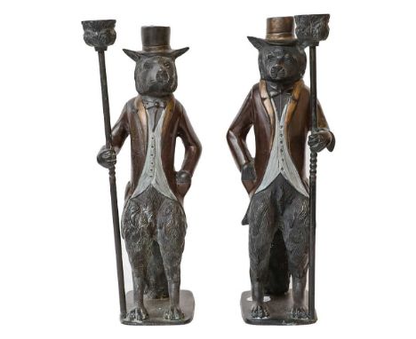 A pair of zoomorphic bronze candlesticks formed as a pair of foxes in formal attire, together with a pair of antlers, two sil