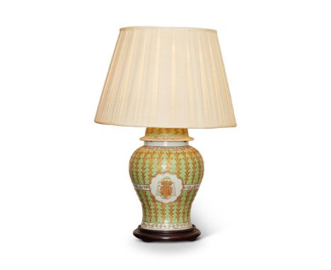 A FAMILLE ROSE GREEN 'ARMORIAL' VASE AND COVER19TH CENTURYAdapted as lamp 68cm high including shade, the vase 35cm highProven