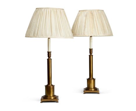 A PAIR OF BRASS CANDLESTICKSEARLY 20TH CENTURYConverted as lamps, with shades47cm to top of fitmentCondition Report: Light bl