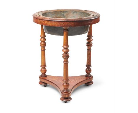 AN OAK GLOBE STAND JARDINÈRE19TH CENTURYWith a copper liner, on turned legs joined by a triform base with turned disc feet, a