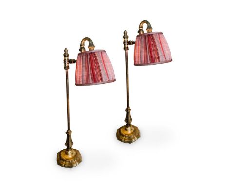 A PAIR OF ADJUSTABLE BRASS TABLE LAMPS20TH CENTURYWith knopped tubular stems, on moulded, shaped circular feet, with Robert K