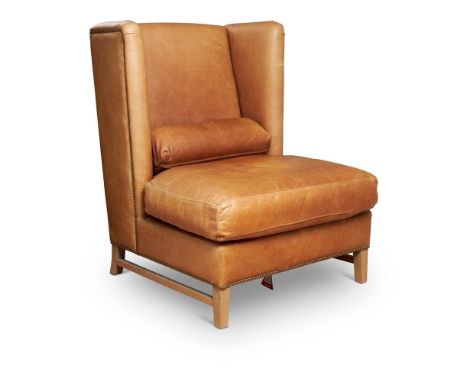 A HIGH BACK WING ARMCHAIRMODERNUpholstered in nailed light tan hide, on square legs106cm high, 84cm wide, 80cm deepCondition 