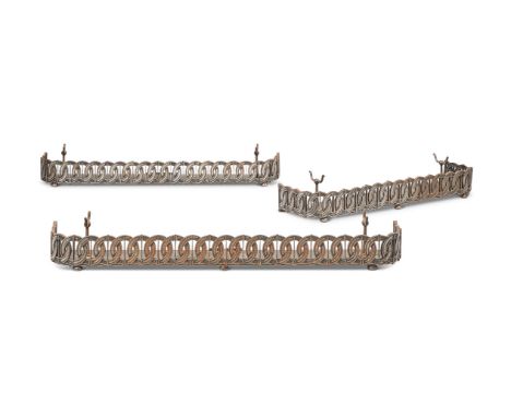 A SUITE OF THREE SIMILAR CAST STEEL FENDERSLATE 19TH CENTURYWith pierced guilloche decoration and tool bracketsLargest 13cm h