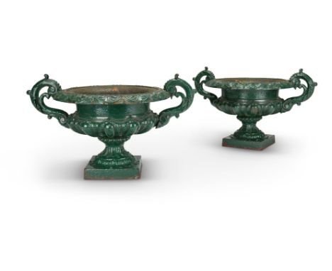 A PAIR OF VICTORIAN GREEN PAINTED CAST IRON URNSPOSSIBLY BY HANDYSIDEOf campana form with twin handles30cm high, 48cm wideCon