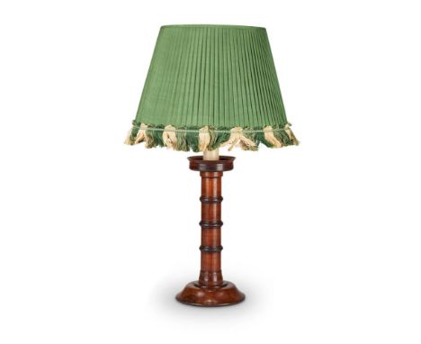 A TURNED WOOD CANDLESTICK BASEThe cylindrical column with three ring knops, fitted for electricity as a lamp82cm high includi