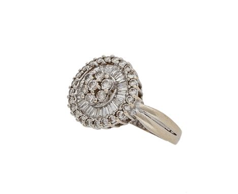 A diamond dress ring, composed of a cluster of round brilliant-cut diamonds to a surround of tapered baguette-cut and round  