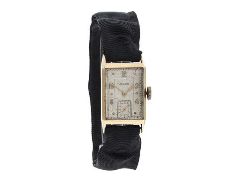 A circa 1940's 14 carat gold Gentleman's wristwatch by Jaeger-LeCoultre, the rectangular silvered dial with Arabic markers an