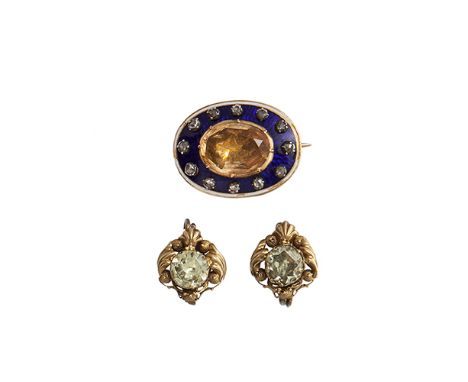 A Georgian brooch, composed of an oval mixed-cut foiled back yellow topaz within a pinched collet setting to a blue enamel su