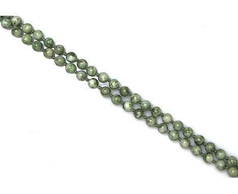 A jade beaded necklace, composed of uniform-sized mottled pale green and spinach green knotted beads, length approx. 72cm 