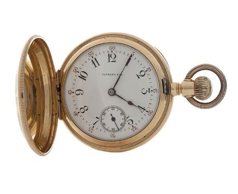 An 18 carat gold full hunter pocket watch by Tiffany &amp; Co. the crested hood opening to a circular white ceramic dial with