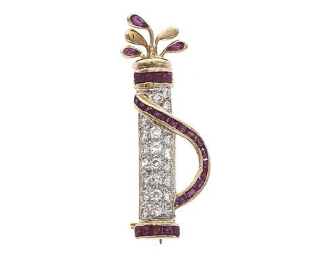 A diamond and ruby brooch of a golf bag & clubs, set throughout with round brilliant-cut diamonds, calibré-cut and pear-shape
