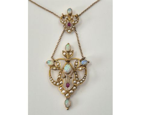 A Belle Epoque style 9ct. gold, opal, seed pearl and ruby pendant necklace, of typical openwork form, the fine cable link cha