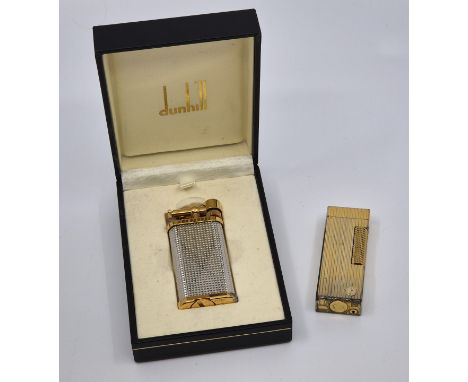 A Dunhill Unique gold and silver plated lighter, with booklet in Dunhill box, together with a&nbsp;Dunhill gold plated Rollag