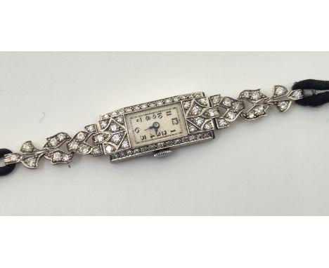 An Art Deco platinum diamond set cocktail watch, manual movement, having silvered rectangular Arabic numeral dial, 11.5mm wid