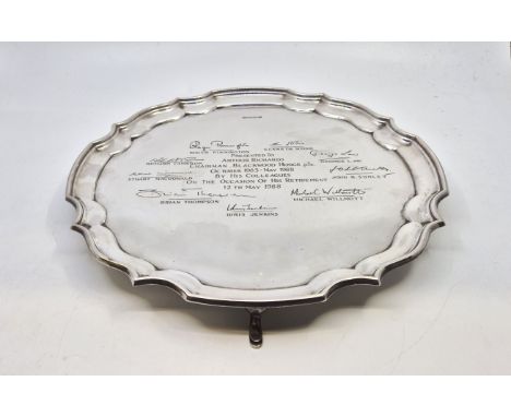 A silver presentation salver, by F Drury Ltd, Sheffield 1988, with scrolling border, raised on four hoof supports, diameter 3