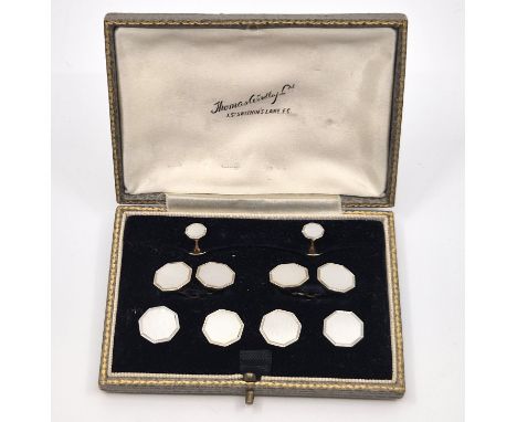 A mixed 18ct. and 9ct. gold, mother of pearl set dress shirt set, of octagonal form with engine turned decoration, comprising