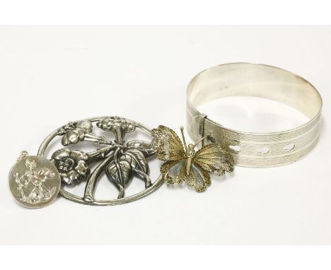 A Charles Horner silver sprung belt style bangle, with engine turned decoration, a sterling silver Danecraft floral brooch, a