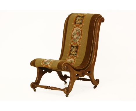 A Victorian walnut slipper chair, with tapestry upholstery