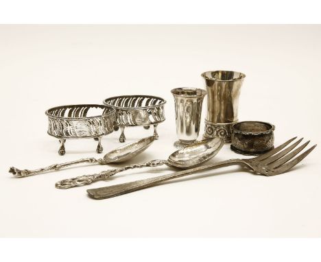 A pair of pierced silver open salt cellars, a.f., lacking glass liners, a Victorian silver fish serving fork, a silver napkin