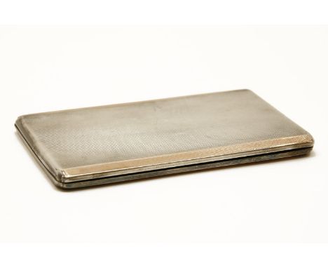 An engine turned silver and copper banded cigarette case