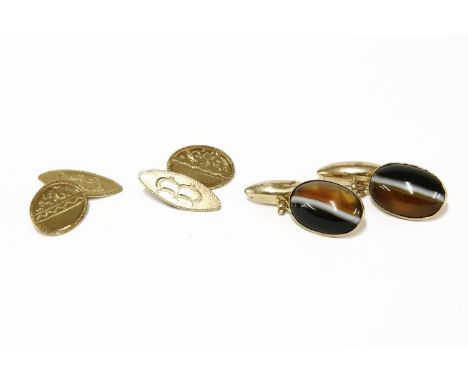 A gilt metal South African bangle with applied spade and bucket decoration, a pair of oval and navette shaped chain link cuff