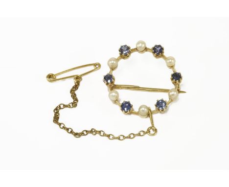 An early 20th century gold sapphire and seed pearl circle brooch, marked 7804.72g