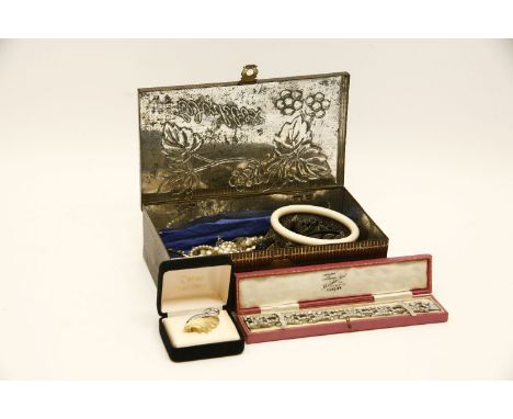 A tin of costume jewellery, including an ivory bangle paste set bracelet