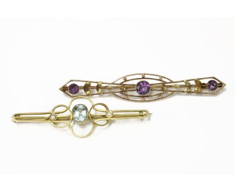 A gold oval cut blue paste and seed pearl bar brooch, marked 9ct, and an Edwardian two colour gold three stone amethyst bar b