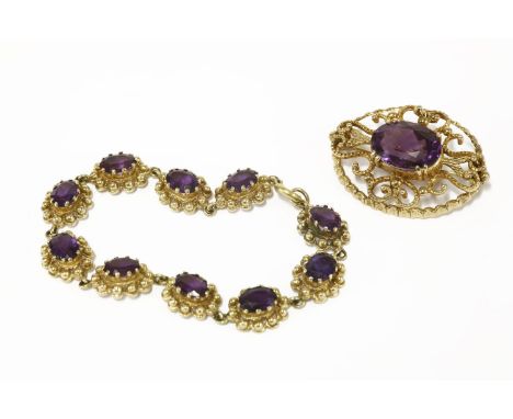 A 9ct gold single stone oval cut amethyst brooch, double claw set to a scrolling pierced back, and a gold oval cut amethyst p