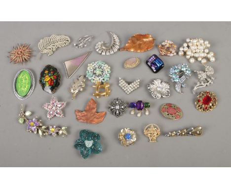 A collection of costume jewellery brooches to include Monet, Movitex, leaf, and floral examples.  