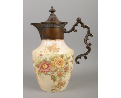 A W&amp;R Carlton Ware ewer, with decorative handle, hinged top in the Peony design. Height: 25cm.  Crazed. Hairline cracks t