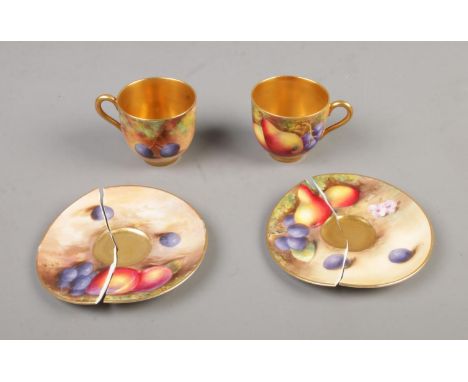 A pair of Royal Worcester hand painted gilt china cups and saucers decorated with fruit.  Crack on one cup and both saucers s