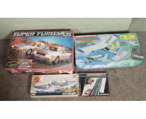 A collection of boxed toys. Includes Super Turismos, Scalextric lap counter, Airfix HMS Belfast and Jamara Cessna model plane