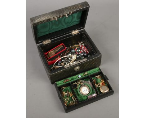 A leather jewellery box with fitted interior and contents. Includes silver fob watch, vintage costume jewellery, etc.  